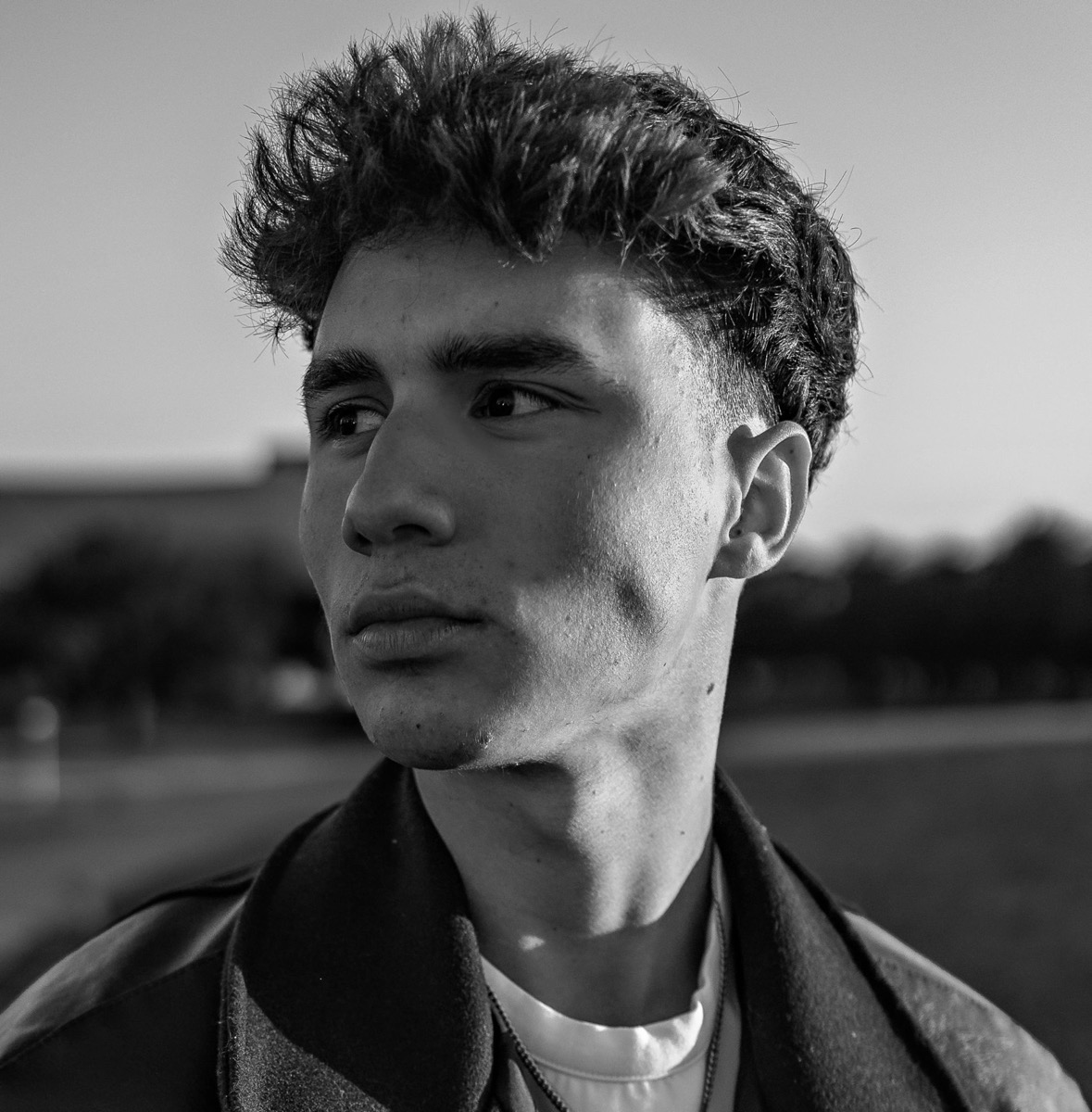 Black-and-white portrait of Lincoln Pumphrey outdoors, looking off to the side